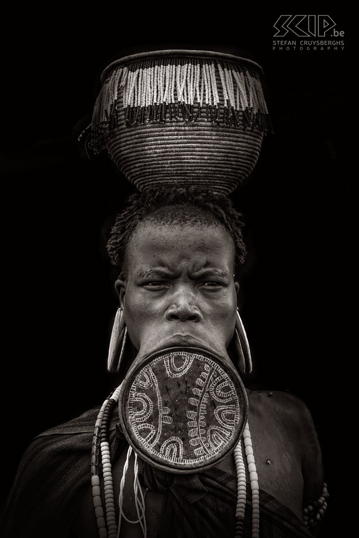 Mago - Mursi woman with impressive lip plate The lip plate is only worn by women and it is made from clay and inserted into a pierced hole in the lower lip. Some plates have a diameter of 23cm. The lip is pierced around the age of 15 or 18 before a women gets married. Stefan Cruysberghs